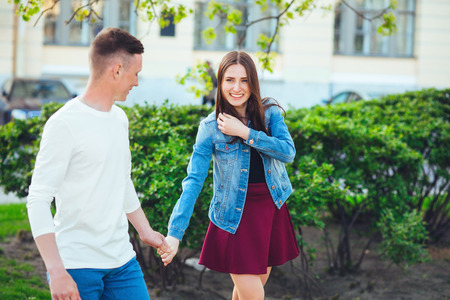 Couple of tourists taking a walk in a city street sidewalk in a sunny dayの写真素材