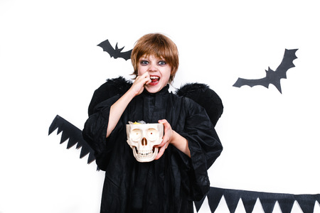 Happy boy in a black angel costume having funの写真素材
