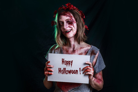 Close-up portrait of horrible zombie woman with wounds. Horror. Halloween poster.の写真素材