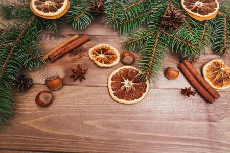 Christmas or New Year brown wooden background, Christmas food decor with fir tree.Xmas decorations, space for a text, view from aboveの写真素材
