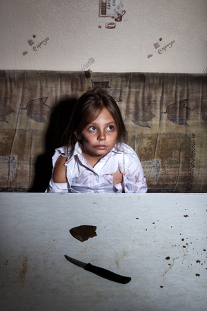 Child abuse. Poor child in slum begging you for help concept for poverty or hunger people,の写真素材
