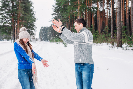 Cheerful young couple having fun in winter parkの写真素材