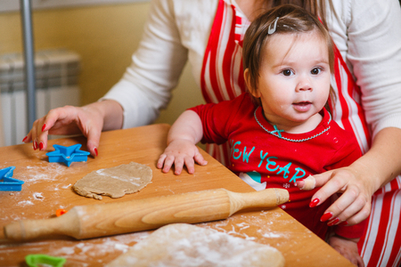 Family with children preparing cookies for Xmas in kitchenの写真素材