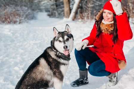 Young girl with her husky dog in winter park. Domestic pet. Huskyの写真素材