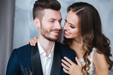 Wedding couple hugging each other indoor.Close-up portrait of wedding couple . Beauty bride with groom.の写真素材