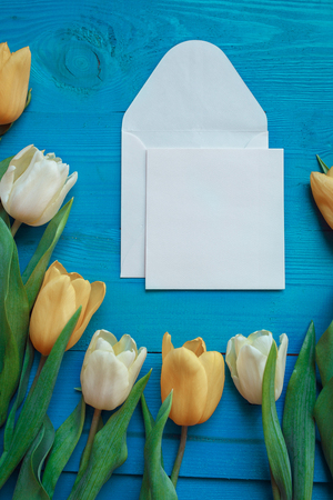 Bouquet of Tulips with card for text on turquoise rustic wooden background . Spring flowers. Womans Day and Mothers Day .の写真素材