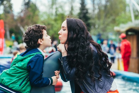 Son and mother in the amusement park.の写真素材