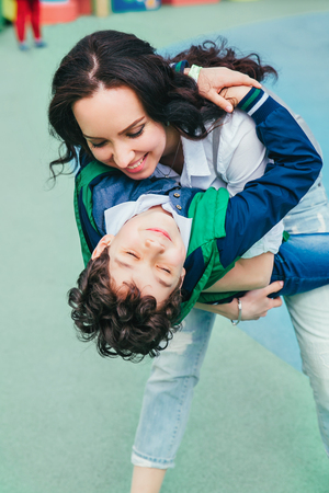 Mother and son child playing having fun together in sunny summer dayの写真素材