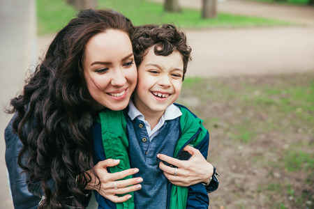 happy family in spring park. Young mother and her son spending time outdoor on a summer dayの写真素材