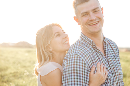 Young romantic couple hugging outdoors in summer dayの写真素材