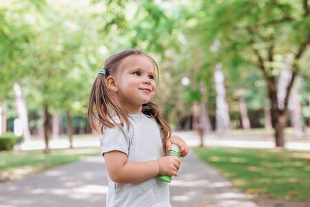 Portrait of funny beautiful little girl in the summerの写真素材