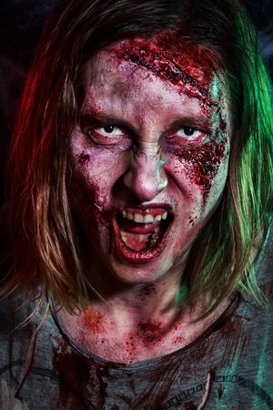 Close-up portrait of horrible zombie woman with wounds. Horror. Halloween make-up and costumeの写真素材