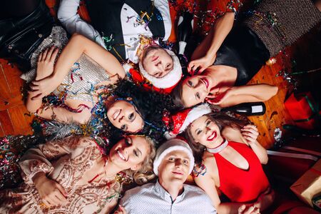 Group of friends at club having fun and lying on the floor .New years partyの写真素材