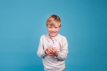childrens pocket money. Little boy with piggy Bankの写真素材