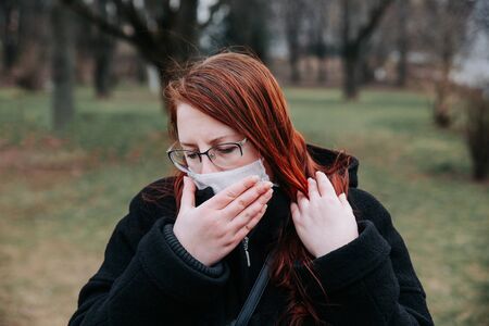 COVID-19 Pandemic Coronavirus Woman in city street wearing face mask protective for spreading of disease virusの写真素材