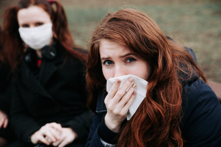 European woman feeling bad on the street in the city. COVID-19 Pandemic Coronavirus