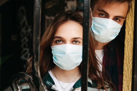 Coronavirus Covid-19.Stay at home Stay safe concept. Young couple wearing masks for protectの写真素材