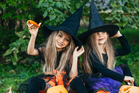 Happy Halloween. Children in suits and with pumpkins having fun outdoor