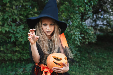 Cute girl in witch costume on Halloween trick or treat