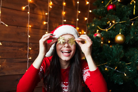 Portrait of beautiful woman wear santa hat having fun on Christmas backgroundの写真素材