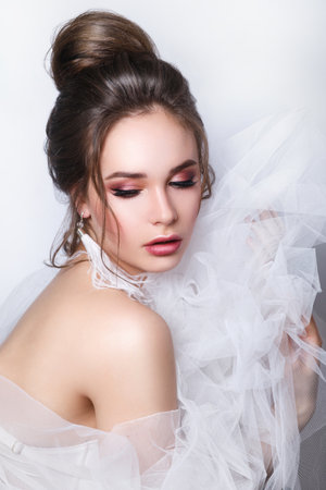 Beautiful bride with fashion wedding hairstyle on white backgroundの写真素材
