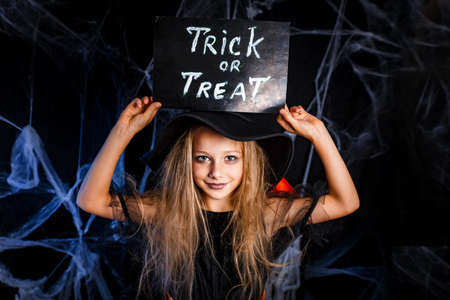 Little girl in Halloween costume trick or treating. Halloween decorationの写真素材