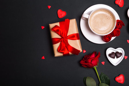 Valentines Day background. Gift, coffee roses, candles, hearts on black background. Valentines day concept. Flat lay,の写真素材
