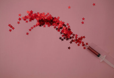 Star shape glitter shooting out of medical syringe. Pink and red colors. Valentine's day  . Love...