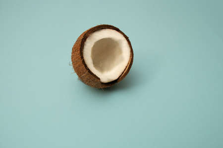 Half of coconut in minimal style. Ripe coconuts on blue background. Copy Space. Pop art design, creative summer concept. Banner. Organic food."の写真素材