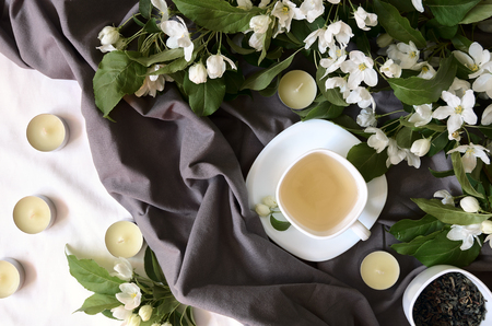 Herbal tea with flowers on gray textile, above viewの写真素材