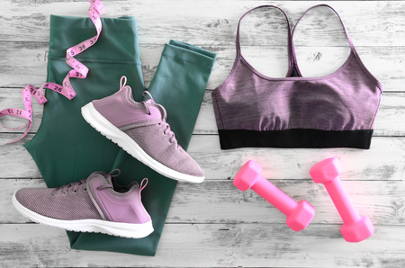 Womens active clothes (leggings, bra) footwear (sneakers) and  equipment (pink dumbbells, tape measure). Active lifestyle concept, Flat layの写真素材