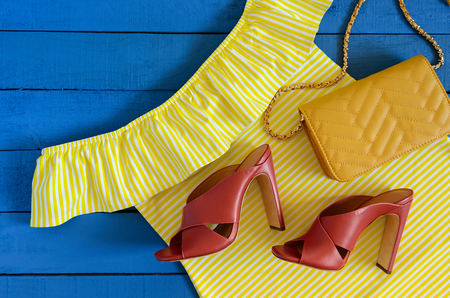 Womens clothing, accessories, footwear (yellow dress,  leather terracotta heel shoes,  crossbody bag). Fashion outfit. Shopping concept. Flat lay. Trendy, saturated colors. Spring summer collectionの写真素材