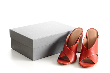 Open toe criss cross leather mule shoes with the cardboard shoebox isolated on white background. Fashion heels shoes, terracotta color.の写真素材