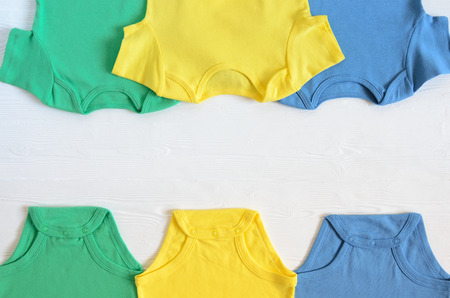 Babies fashion clothing (bodysuints). Shopping concept. Flat lay. Trendy, saturated colors. Wish list or shopping overview for pregnancy and baby shower. Copy spaceの写真素材