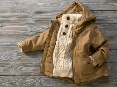 Childrens clothing (knit sweater, hooded canvas jacket). Outfit for little boy. Winter, autumn collection. Fashion, shopping concept. Template for online store, selling. Top view, flat layの写真素材