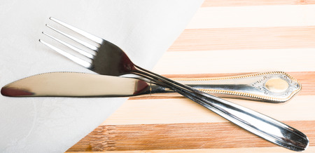 fork and knife on a white napkinの写真素材