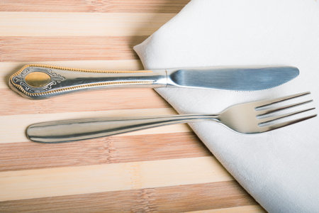 fork and knife on a white napkin