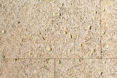 abstract background of coquina. Stone facing of a wall. Stone texture of warm colors.の写真素材
