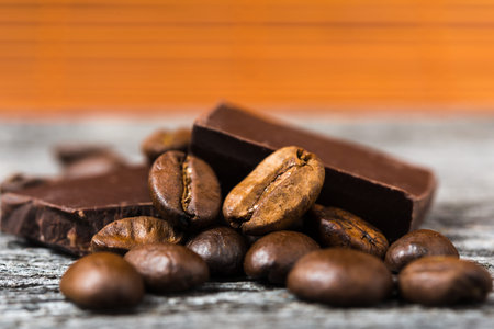 close up of coffee beans and  chocolate on brown backgroundの写真素材
