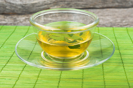 green  tea with mint  on cup of teaの写真素材