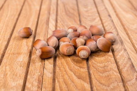 Whole nuts hazelnut on wooden backgroundの写真素材