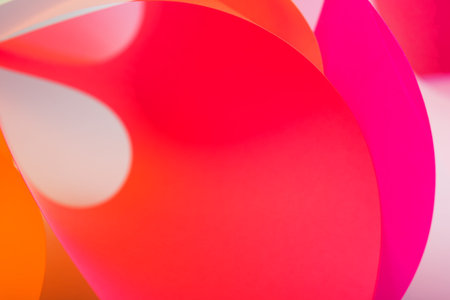 Abstract red paper background. macro photo of curve shapes made up of color paperの写真素材