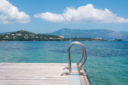 Wooden pontoon stretching into the sea in Greece, Corfuの写真素材