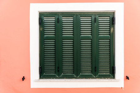 Wooden green window   on pink wall.