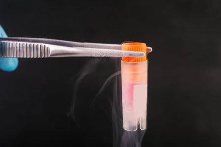 scientist holding  cryotube with cell suspension  on liquid nitrogen bank.