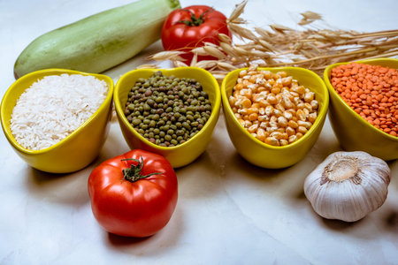 Assorted  grains, seeds, beans  in ceramic bowls  on white concrete table