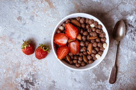 Healthy breakfast  with muesli,  berries and nuts  in bowl on grey background. Healthy food concept....