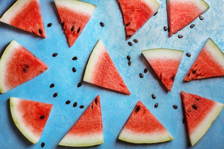Watermelon slices on a  blue rustic wooden  background, flat layの写真素材