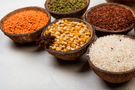 cereals, seeds, beans, grains in a bowls on white tableの写真素材