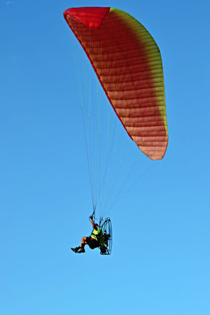 Man flying paraglider for concept design. Travel concept. Freedom, recreation, extreme sport....